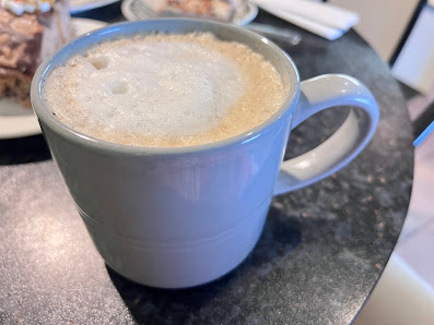 A cappuccino served in a blue-grey mug
